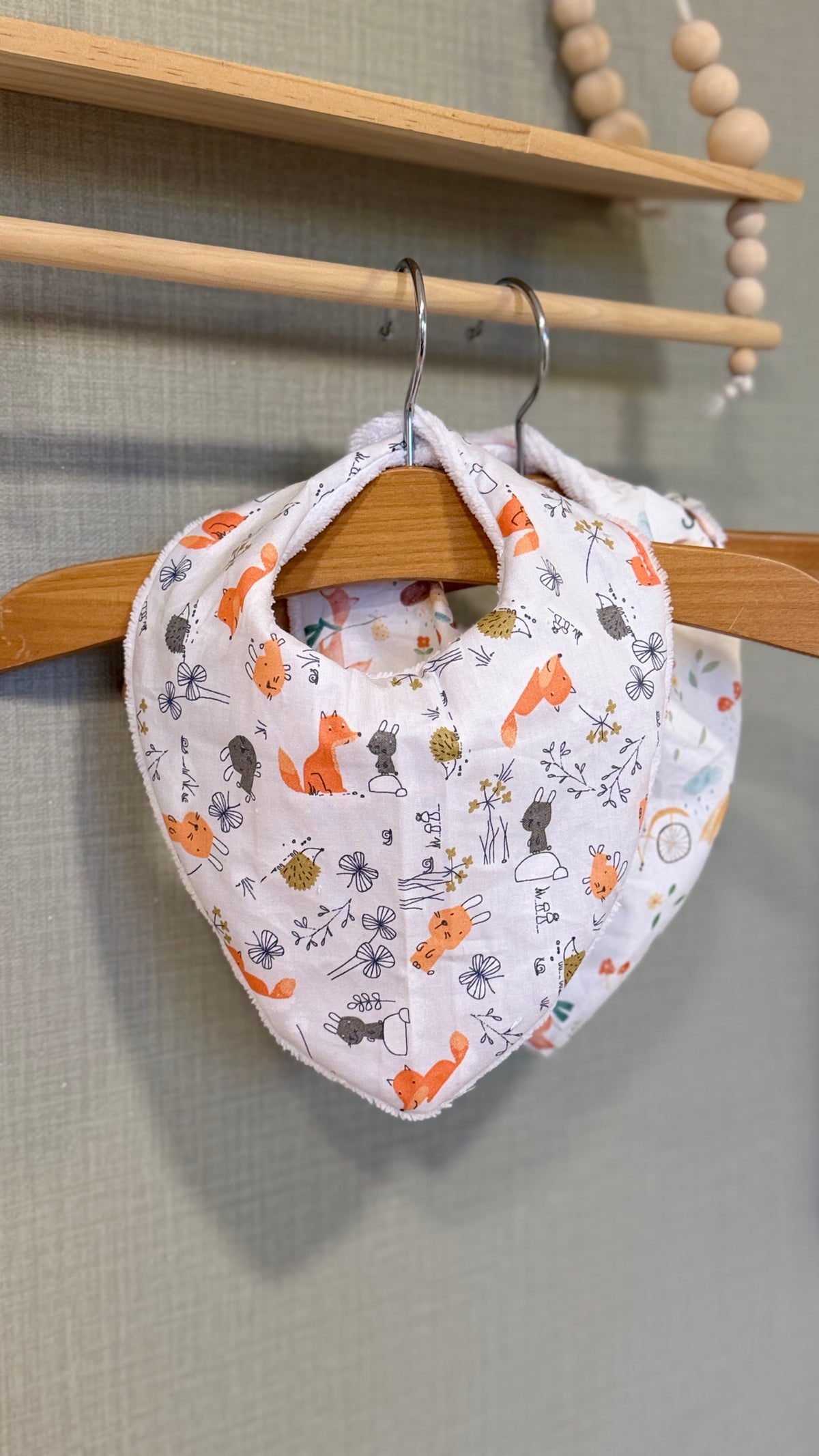 Bavoir bandana bébé Brindille motif renards orange et fleurs grises sur fond blanc